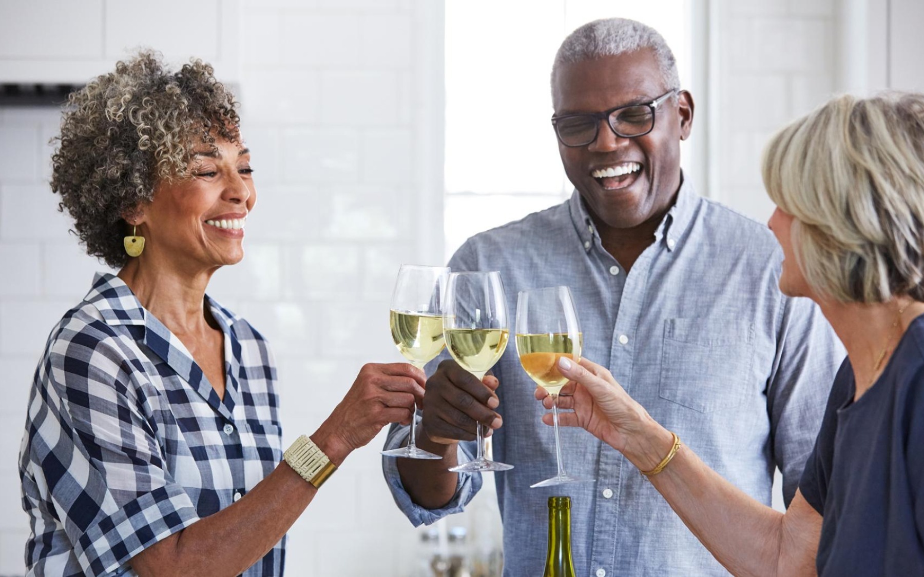 a few people toasting wine glasses