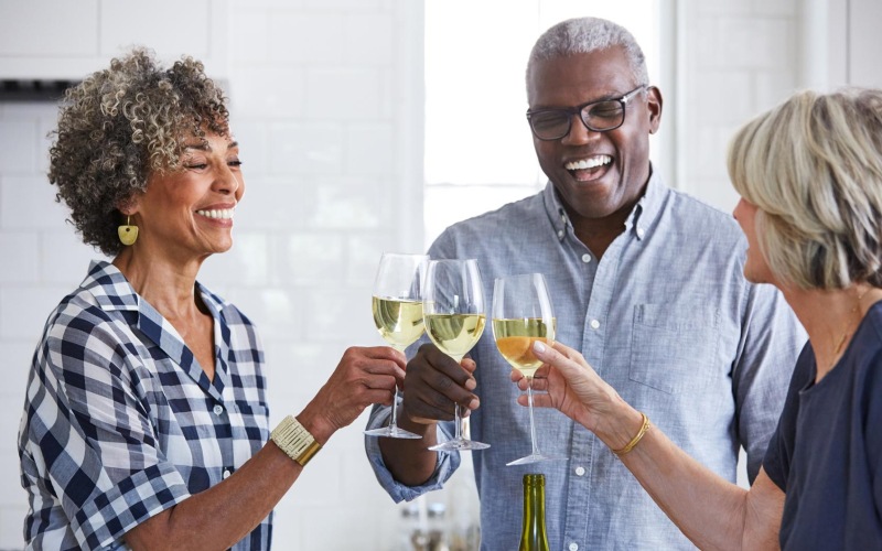a few people toasting wine glasses