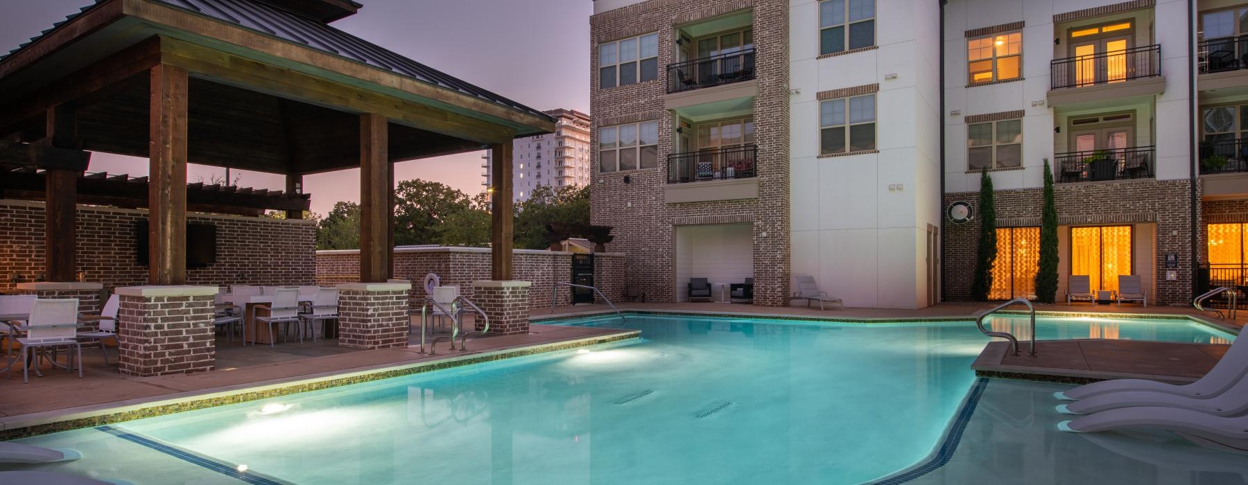 Large sparkling pool with large pool deck and lounge chairs