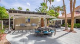 outdoor grilling area with chairs and tables