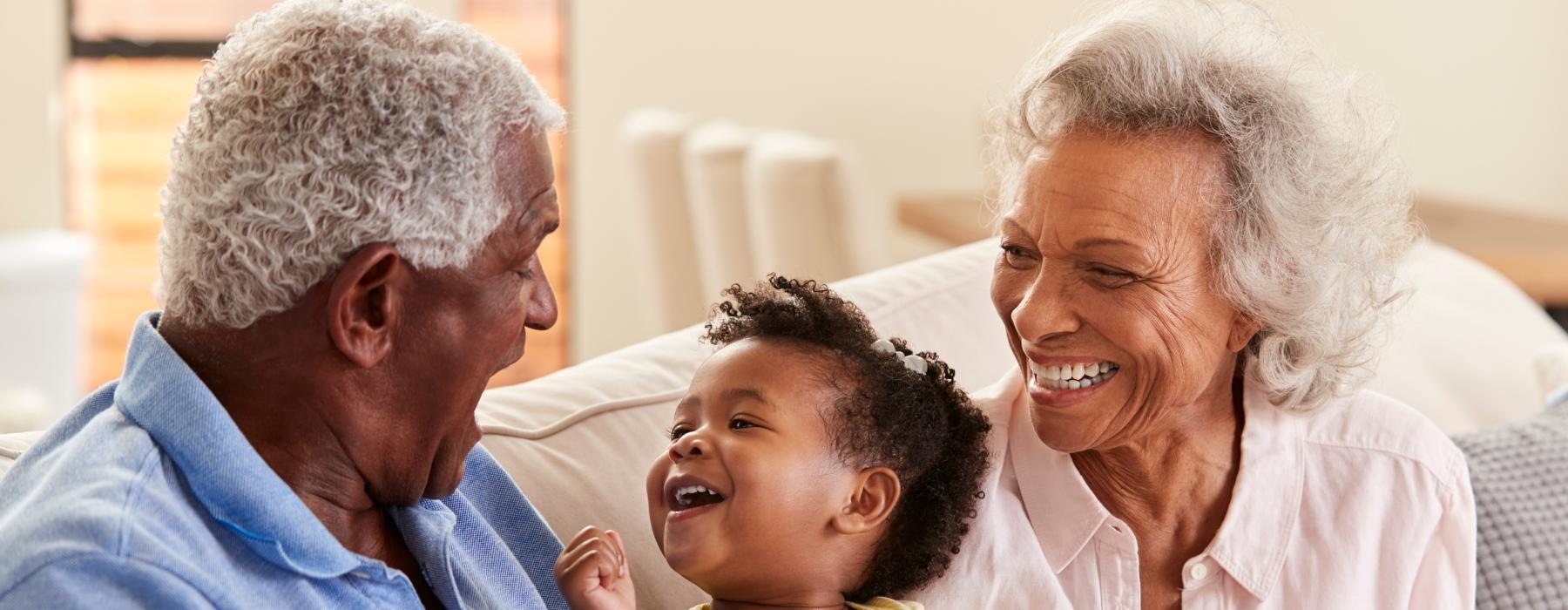 a family sitting on a couch smiling