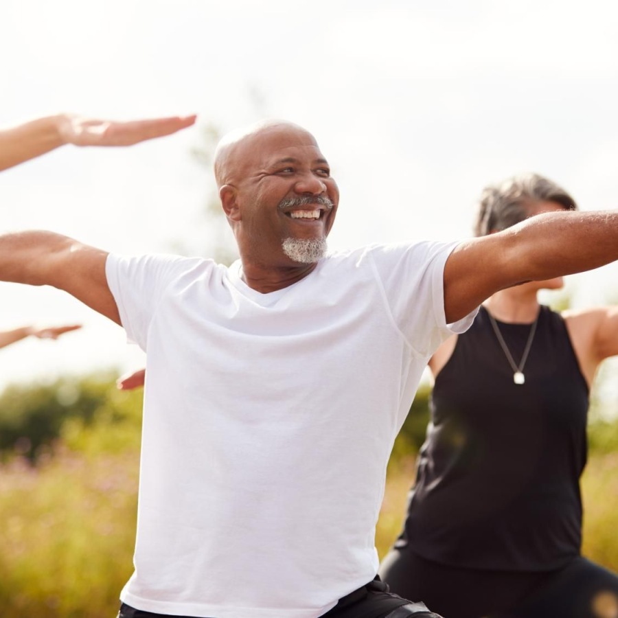Your Wellness is Our Reason for Being Group of people doing yoga outdoors