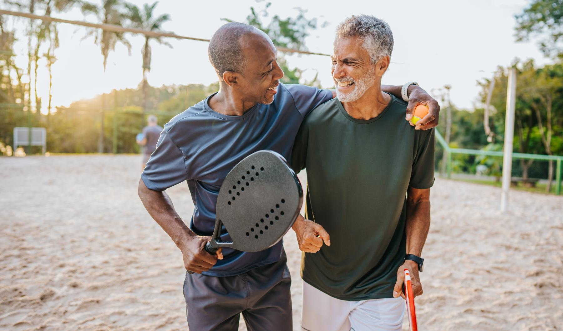 Lifestyle Friends walking on a beach laughing