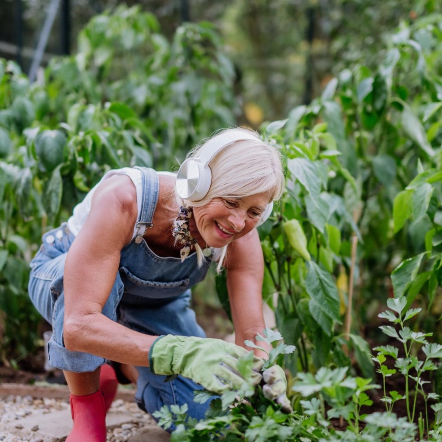 Find your perfect fit at Overture San Marcos a woman squatting in a garden