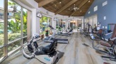 Large fitness center with large windows and plenty of equipment