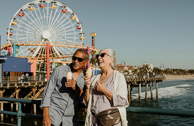 Close to the center of everything a couple standing in front of a ferris wheel