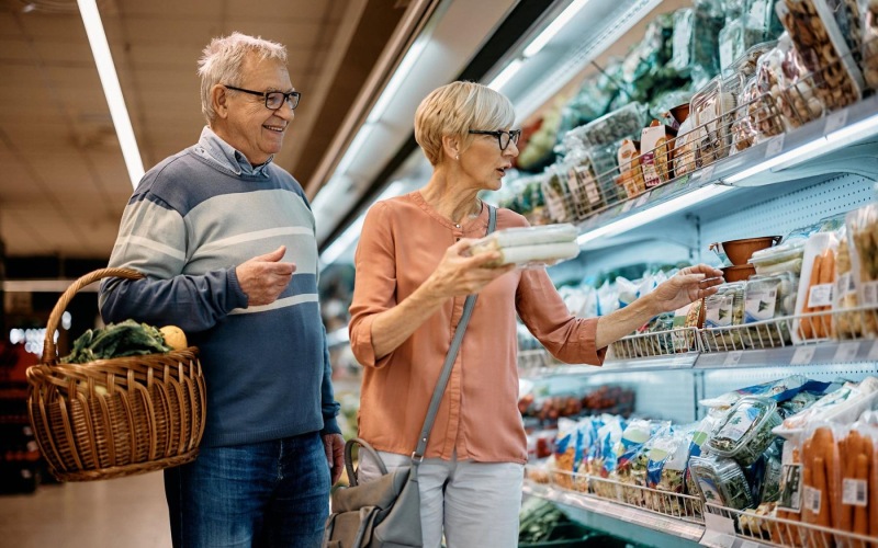 a man and woman grocery shopping