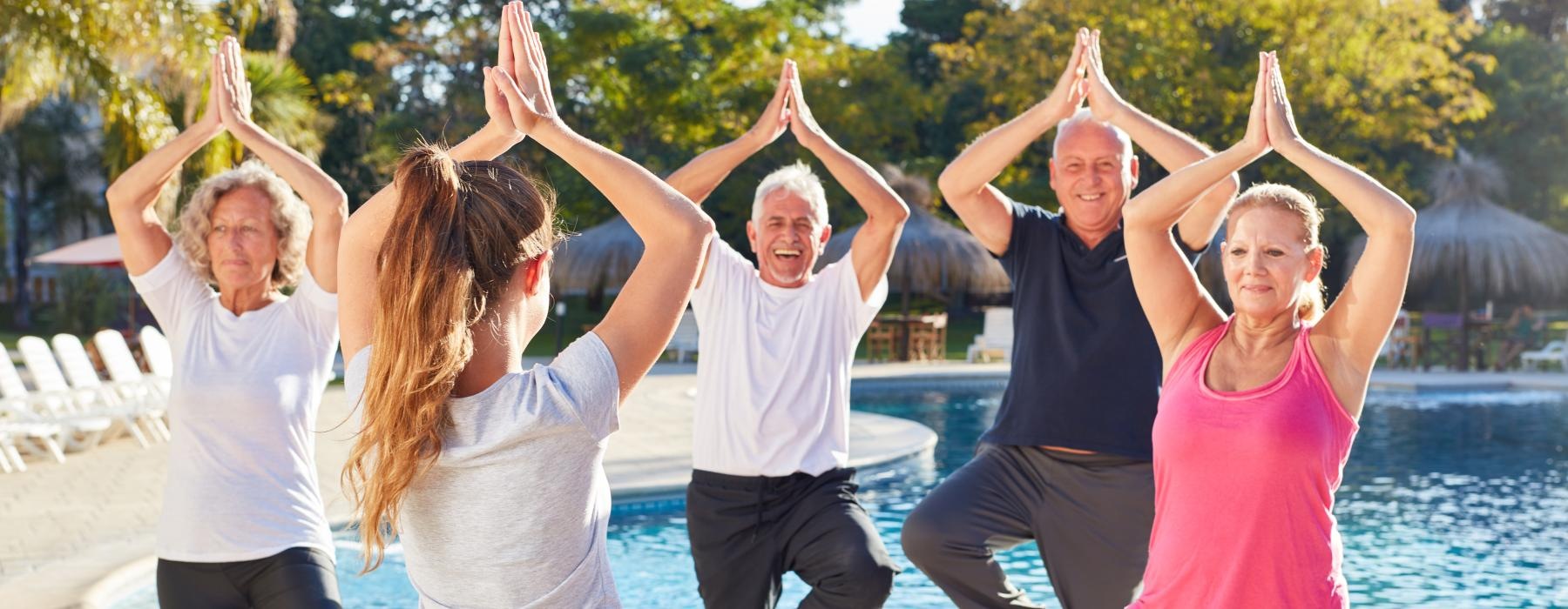 group of people working out near the pool