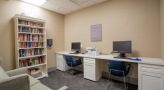 computer work station with a desk and chairs