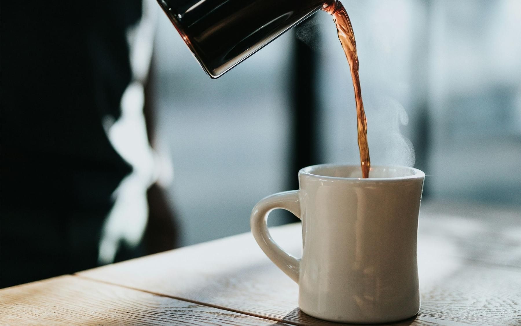 Coffee person pouring a hot coffee