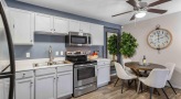 kitchen with a table, chairs and white cabinets