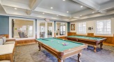 a room with a couch and pool tables