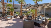 chairs and tables next to a pool