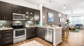 Large well lit kitchen with wood floors