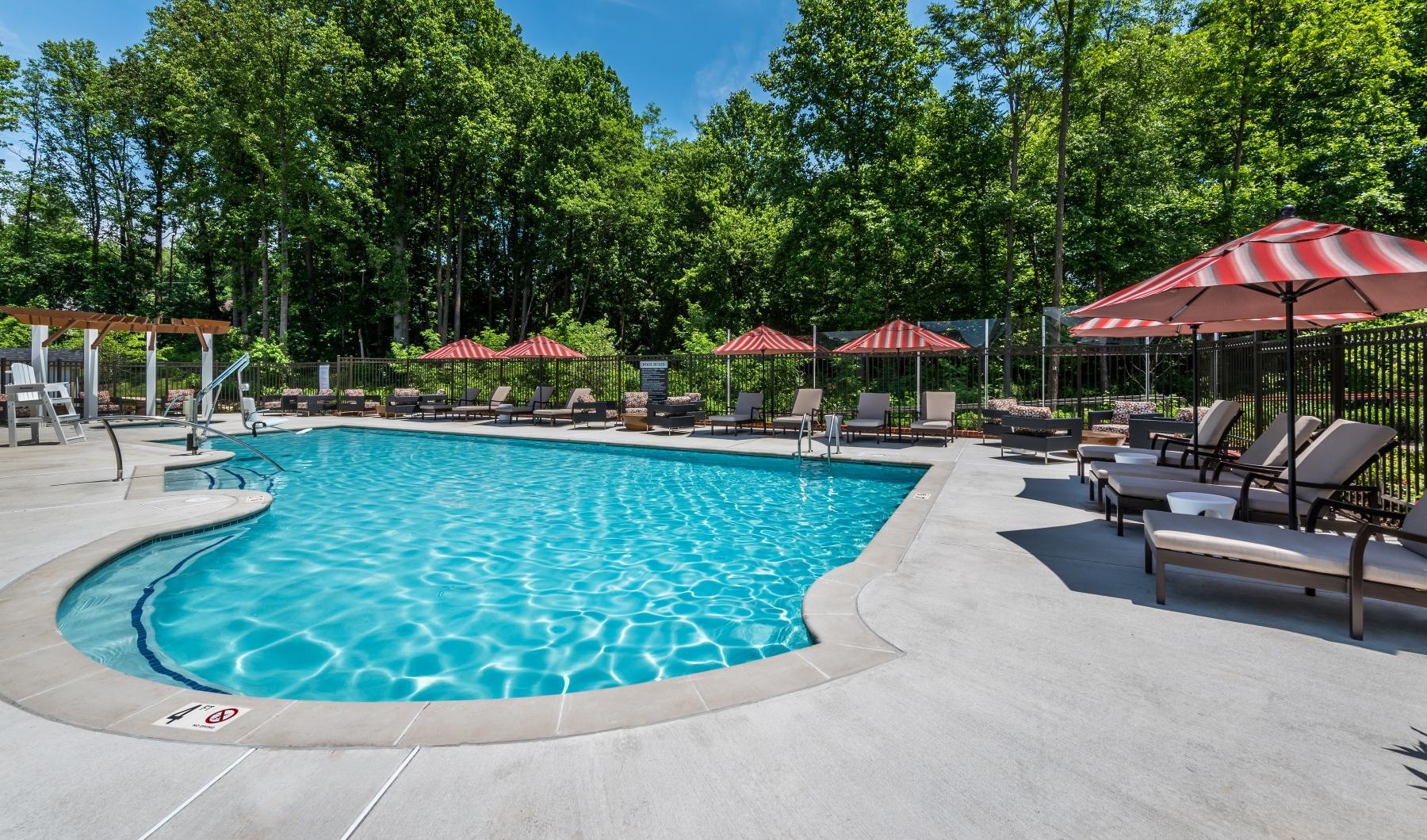 Your Place to Call Home a pool with umbrellas and chairs around it