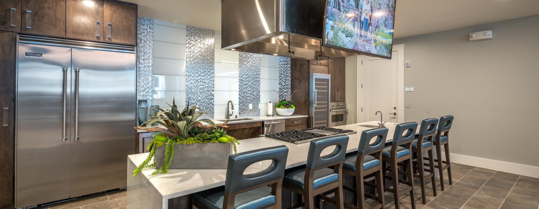 resident kitchen with island and bar chairs