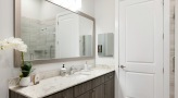 well lit bathroom with brown accents 