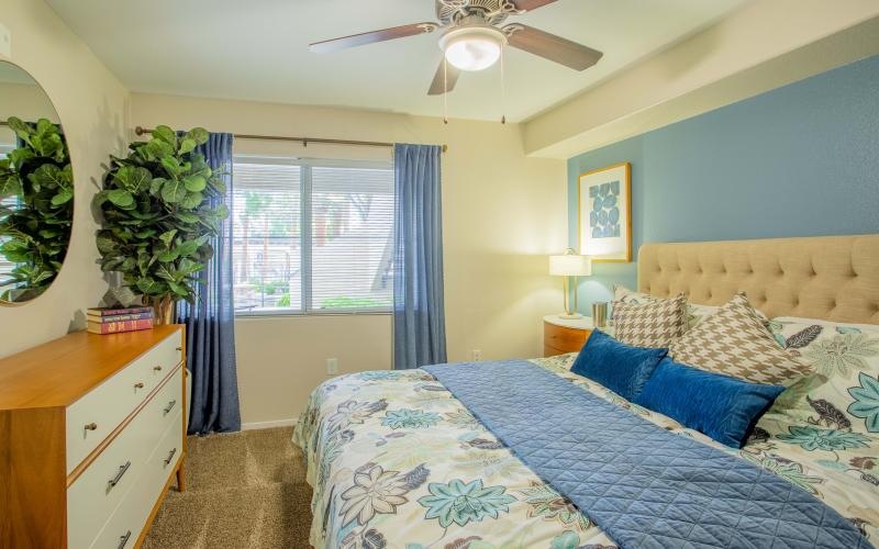 bedroom with a large window and ceiling fan