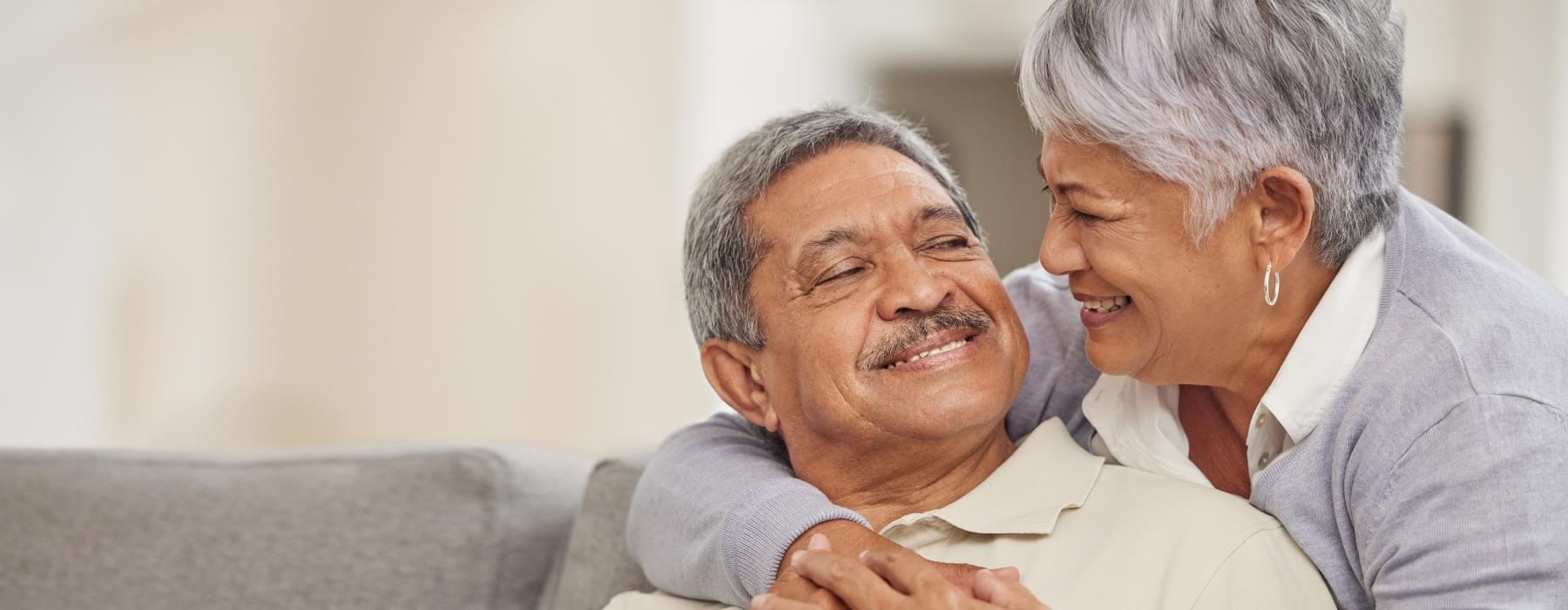 a man and a woman embracing on couch