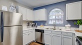 kitchen with a window and white cabinets