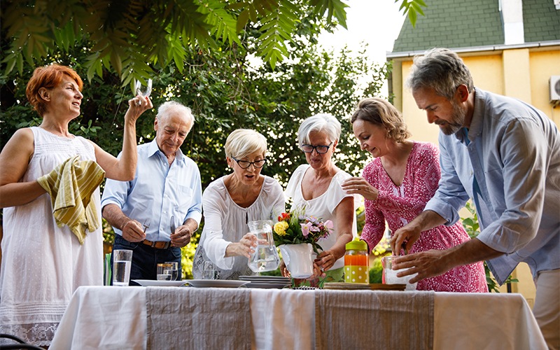 family gathers around a picnic table