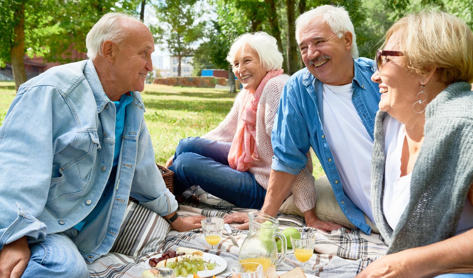 Close to the center of everything a group of people sitting around a table with food