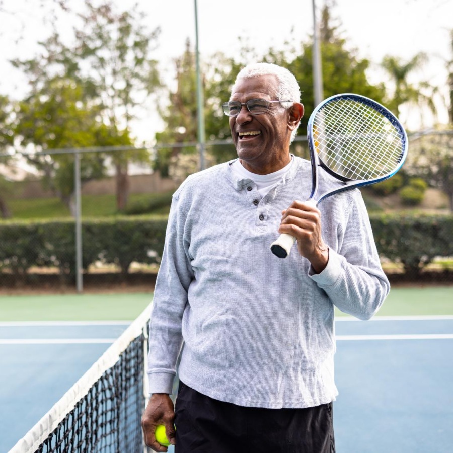 Tennis Court Man smiling after playing tennis