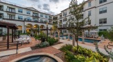 swimming pool in a courtyard surrounded by chairs