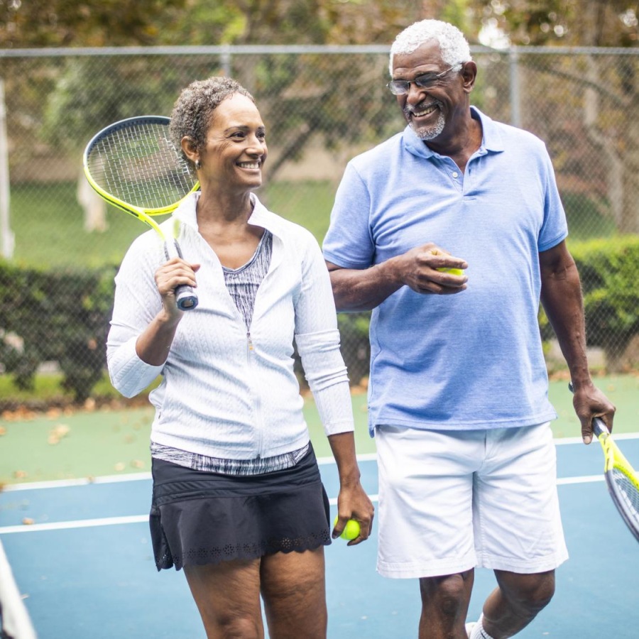 Tennis Court Couple walking on a tennis court after a match