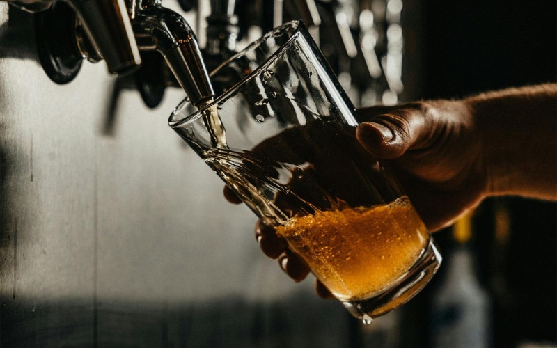 Bustling community with plenty of dining choices someone pouring a glass of beer