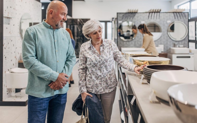 Your new community a man and woman shopping for dishes