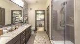 Large bathroom with double vanity sinks and a large mirror