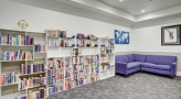 a room with a bookcase and a couch
