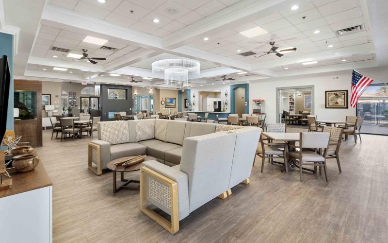 a room with couches, tables and chairs