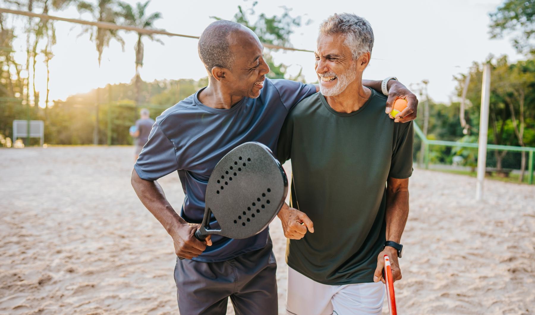 Lifestyle Friends walking on a beach laughing