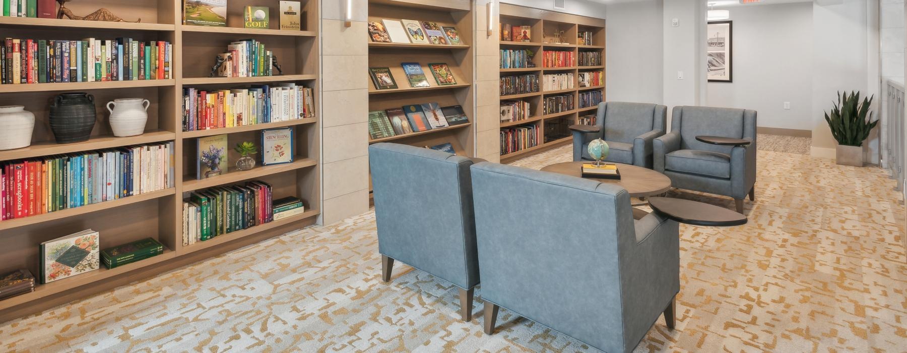 a bright library room with chairs and coffee table