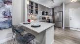 a kitchen with a bar and chairs