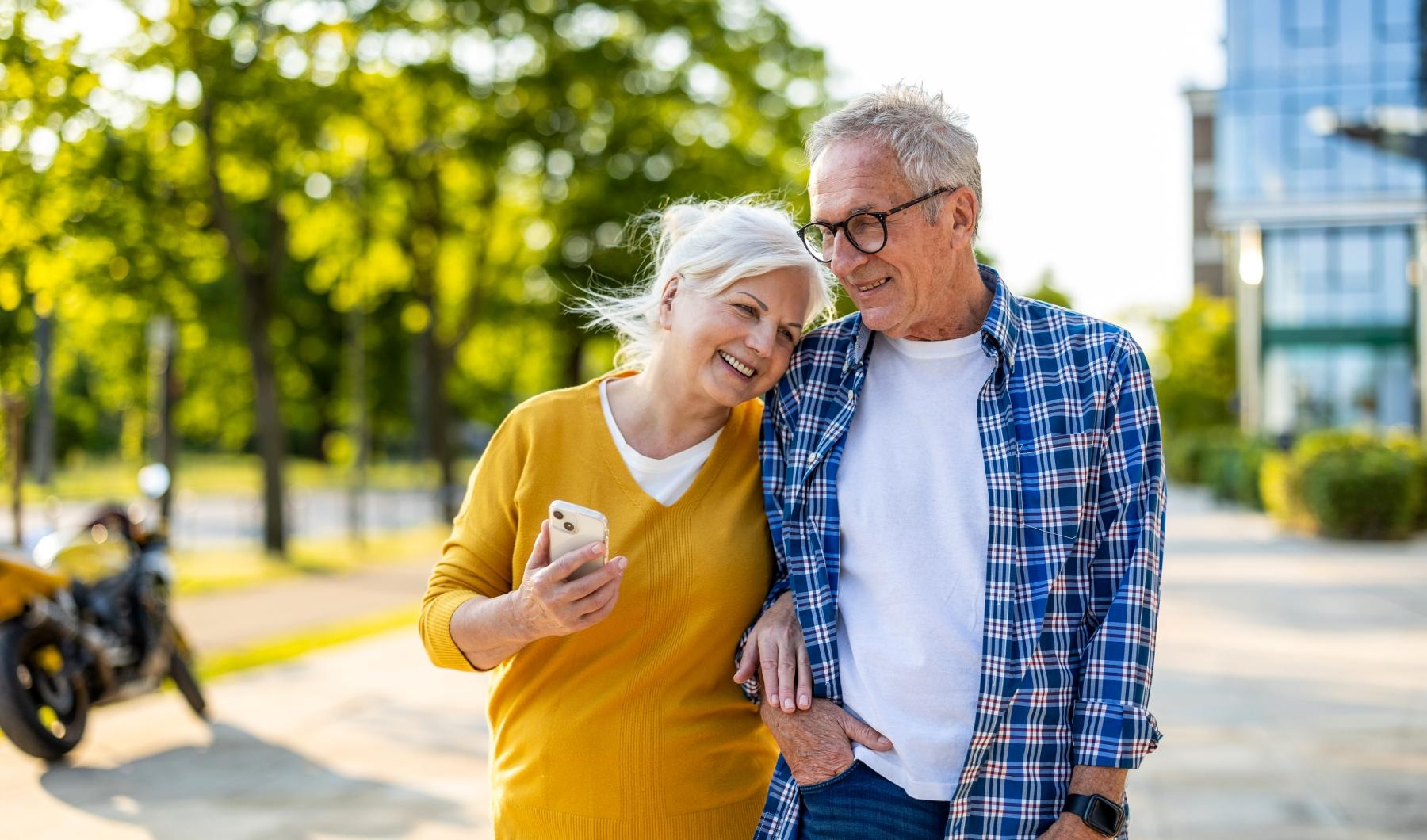 Lifestyle Couple walking down the side walk hugging and smiling