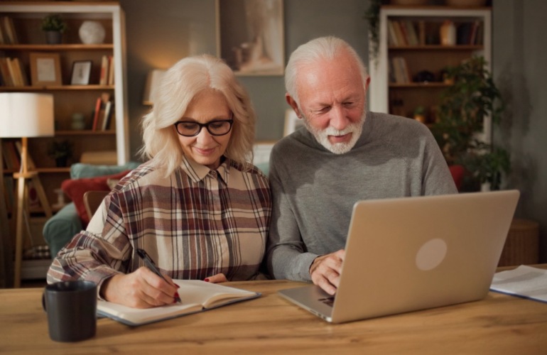a couple looking at a laptop