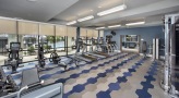 Large fitness center with large windows and plenty of equipment