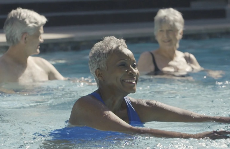 Senior adults swimming in a pool.