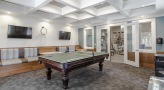 a room with a couch and pool tables