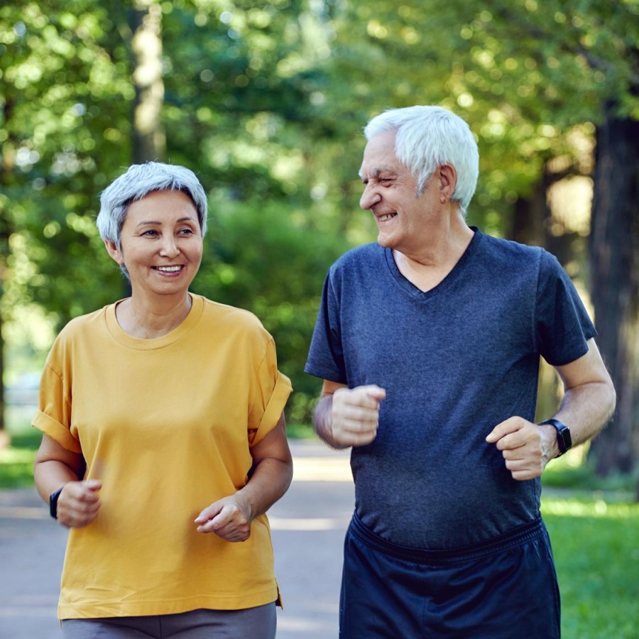 Your Wellness is Our Reason for Being a man and a woman jog in the park together
