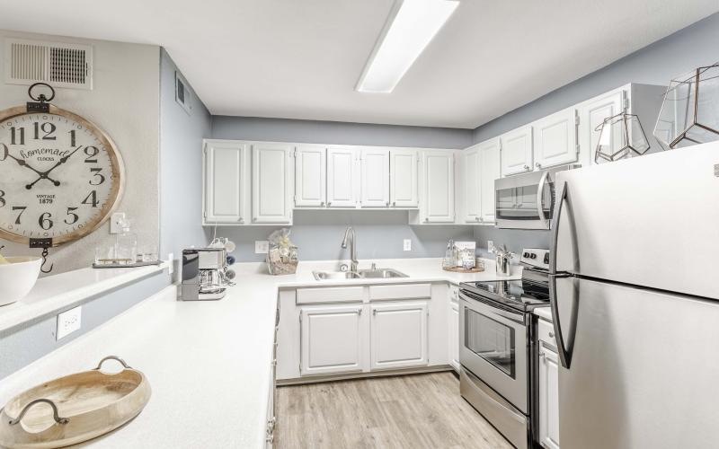 a kitchen with white cabinets