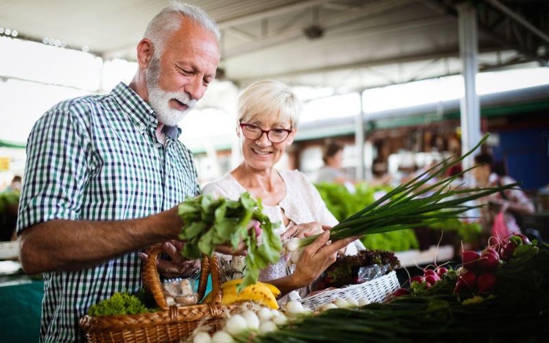 Close to the center of everything a man and a woman at a farmers market