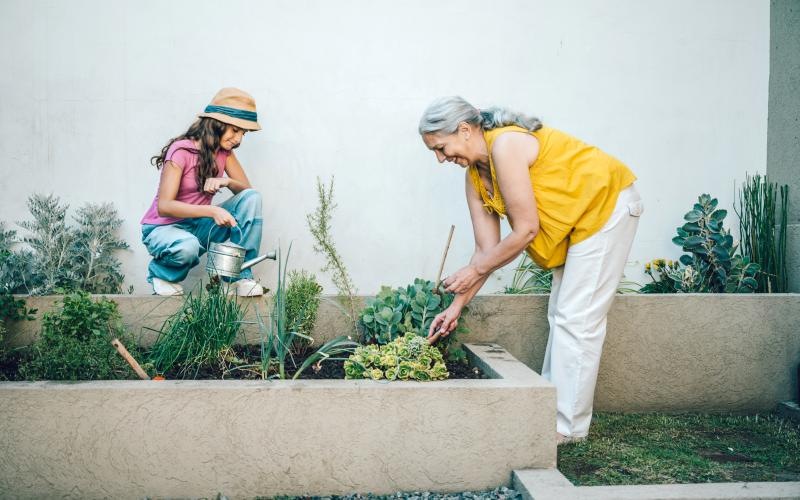 a woman and a child planting plants