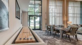 well lit game room with tabletop shuffle board