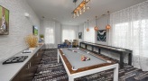 Game room with tabletop shuffle board and billiards