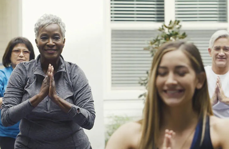 Senior adults taking a yoga class.