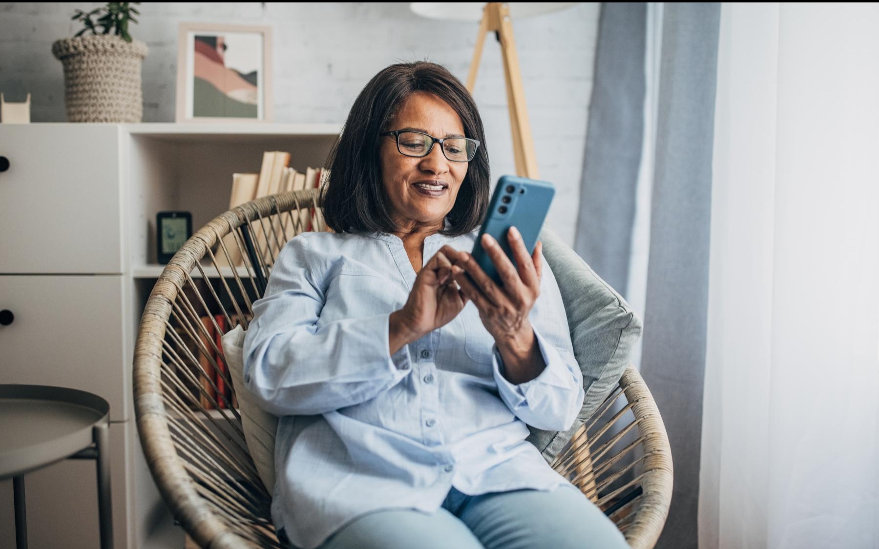 Lady sitting on her phone smiling 